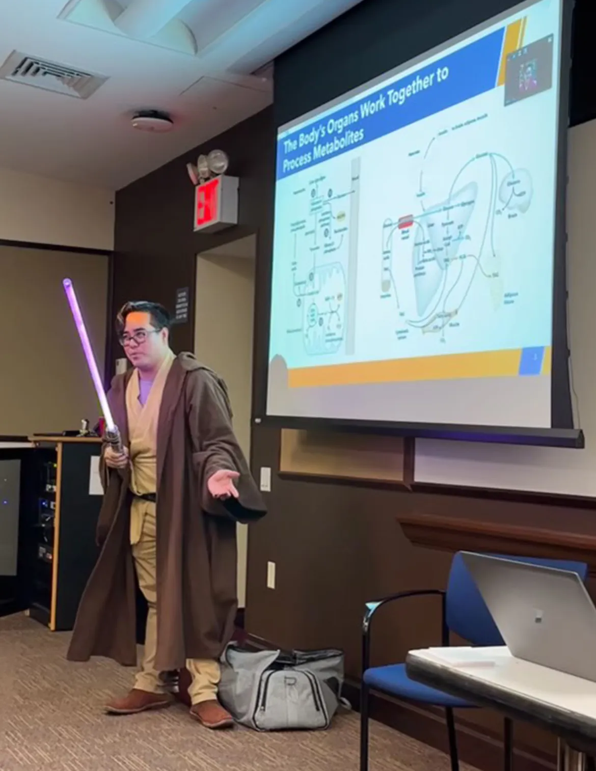 Professor Nam Ho teaches a biochemistry class on Halloween in costume. 