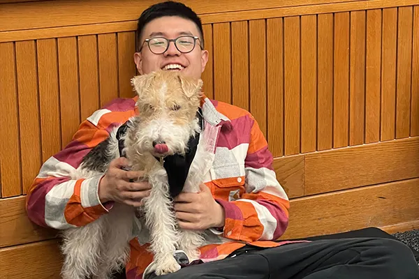 Linhan Dong is pictured with his dog. 