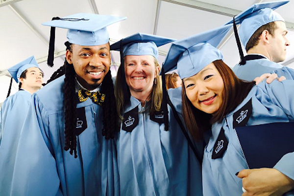 students in blue caps and gowns