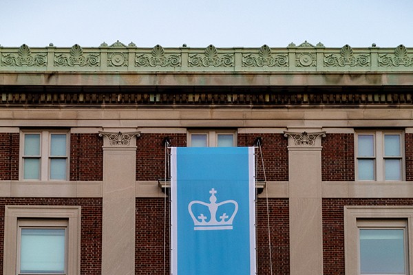 Columbia University banner on red brick building 