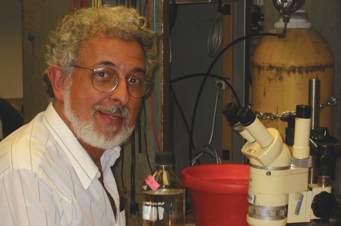 Photo credit: Laura Wolszon Dr. Macagno is pictured seated with a microscope